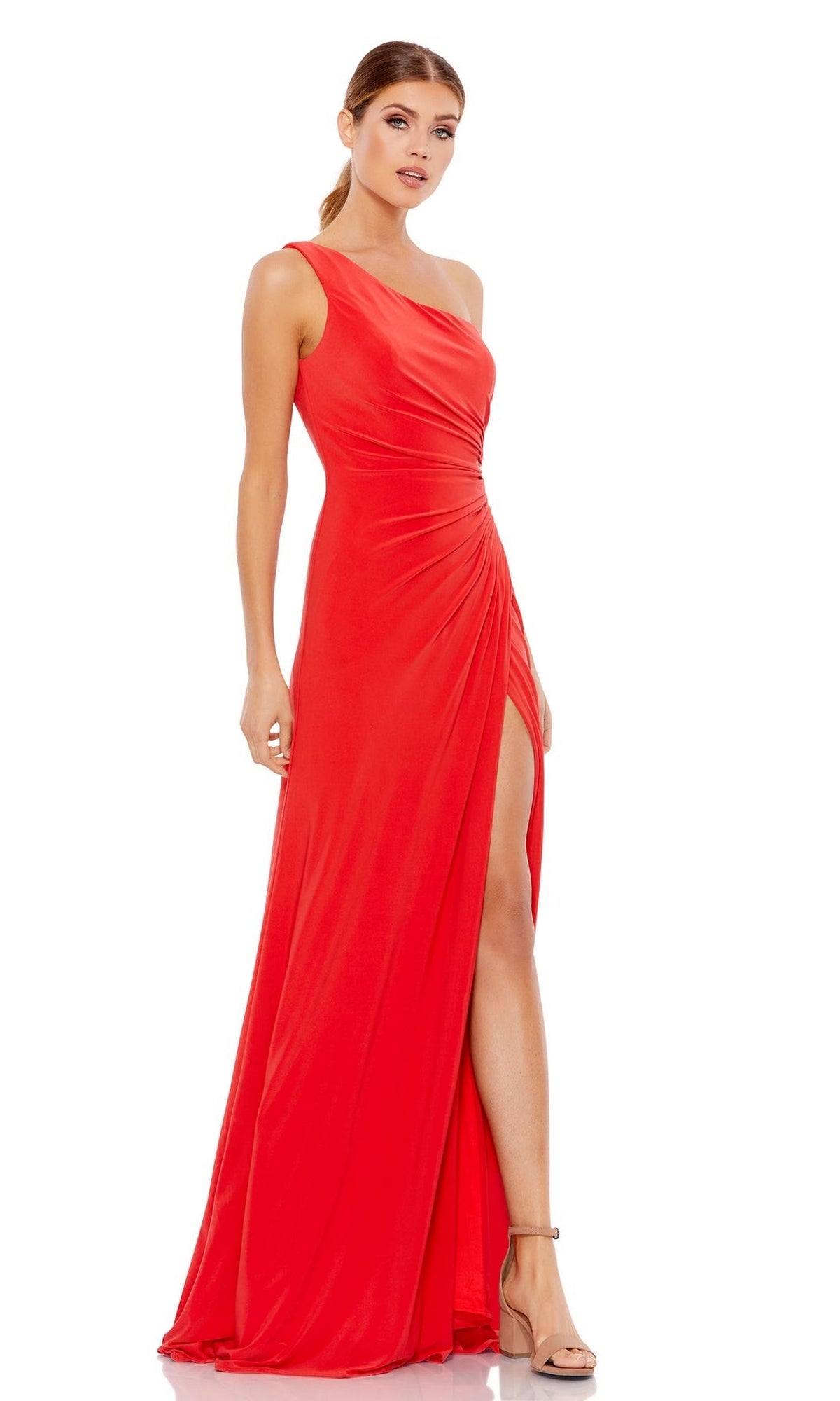A woman in neutral heels poses against a white background, wearing the Mac Duggal 26163—an elegant one-shoulder long formal dress in bright red with a thigh-high slit.